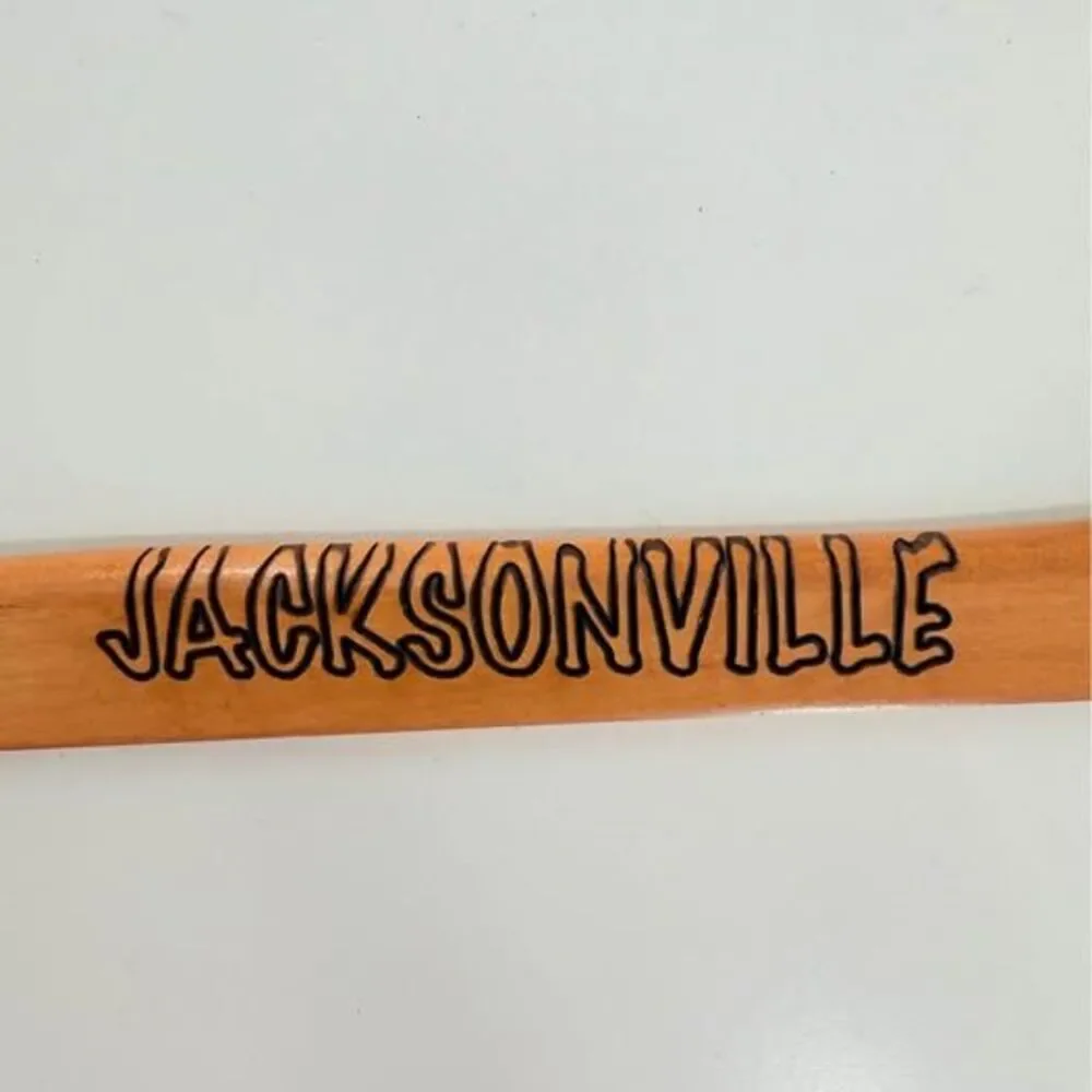 5 custom wood hangers with Jacksonville Jaguars branding.